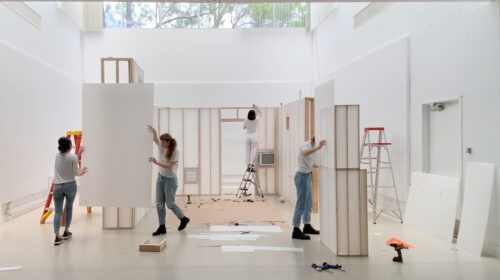 Liz Galvez and students working on sheetrock