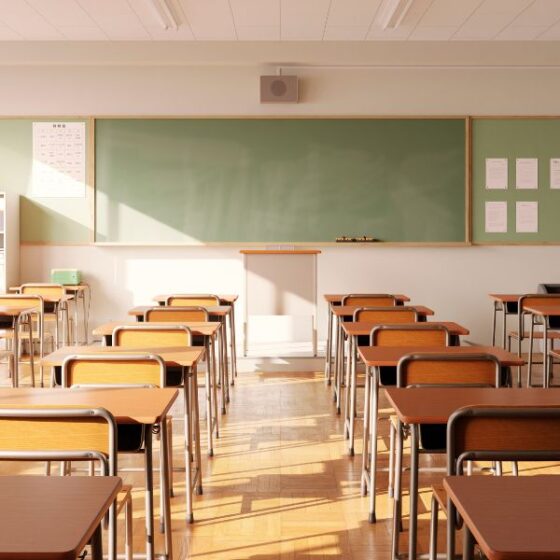 Empty elementary school classroom, desks and chalkboard